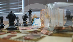 euros on the chess table simulating financial doubts