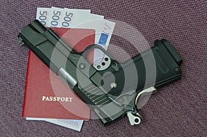 Euros money invested in the passport next to the gun