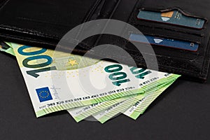 Euros sticking out of the wallet. Paper banknotes of 100 euros each