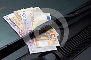 Euros under windshield wiper