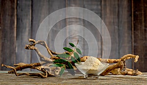 Eurycoma longifolia Jack,dried roots,green leaves and powder on an old wooden background