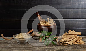 Eurycoma longifolia Jack,dried roots,green leaves and powder on an old wooden background