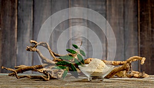 Eurycoma longifolia Jack,dried roots,green leaves and powder on an old wooden background photo