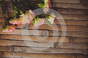 Eustoma and rose lying on a wooden board