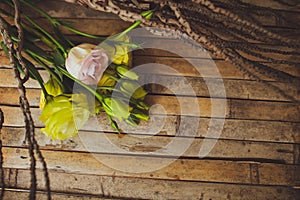 Eustoma and rose lying on a wooden board