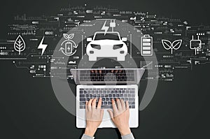 EV concept with person using laptop