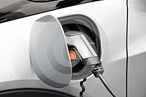 EV or Electric car at charging station plugged in