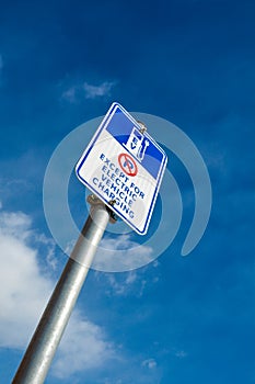 EV - electric vehicle charging station sign on blue sky background