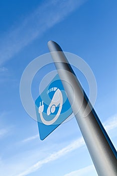 EV - electric vehicle quick charging station sign on blue sky background