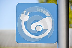 EV - electric vehicle quick charging station sign on blue sky background