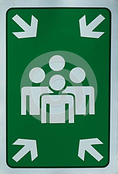Evacuation montage sign in green and white. Gathering point to get people to a safe place during an emergency