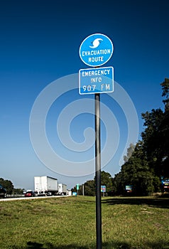Evacuation route  highway sign with traffic and blue skies