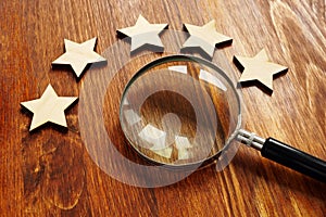 Evaluation and assessment. Five stars and magnifying glass