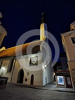 The Evangelical Lutheran Church of the Holy Spirit is an old white building with a clock against the blue sky on one of the