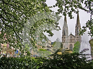 Protestant town church on Augustaplatz in Baden-Baden with branches and flowers in the foreground photo
