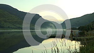 Evaporation fog on Lake Tal-y-llyn at sunrise in summer.