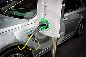 EVBox charger charging a Kia Optima SW plug-in hybrid car at the Brussels Autosalon Motor Show. Belgium - January 18, 2019
