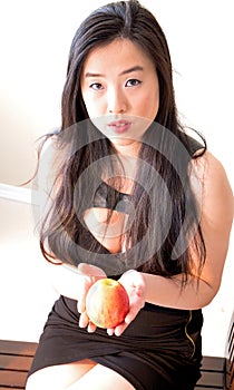 Eve in a lovely black dress offers a fateful apple