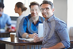 Even break time is productive. Portrait of a two colleagues having a talk over coffee in an office.