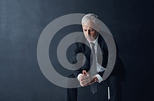 Even CEOs are susceptible to making mistakes. Studio shot of a thoughtful mature businessman against a dark background.