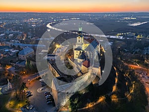Evening aerial view of Nitra castle during winter in front of Nitra river