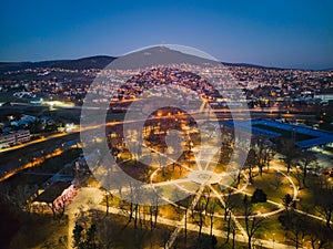 Evening aerial view of the park under Nitra castle during winter with Zobor mountain on horizont