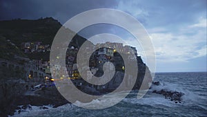 Evening in amazing Manarola village in Italy, beautiful landscape, stormy sea