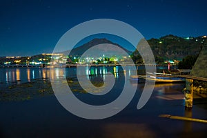 The evening atmosphere at Lake Batur, Kintamani, Bali, with the reflection of Mount Batur and the ambiance of the