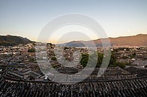 Evening bird eye view of local historical architecture roof building of Old Town of Lijiang in Yunnan, China.