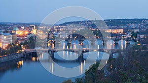 Evening blue hour panorama of city with Vltava river and its bridges, Prague, Czechia