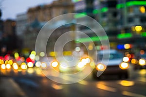 Evening city traffic in a giant metropolis.City light bokeh background.Defocused night traffic lights.