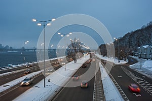 Evening cityscape with auto on highway