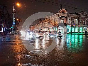 Evening cityscape in rainy weather. Cars and night lights. City of Saratov, Russia