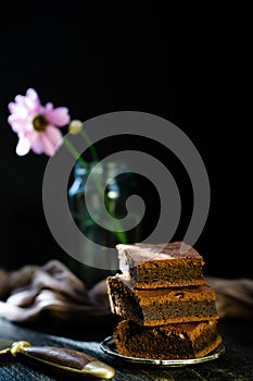 Evening date with chocolate brownie on dark background