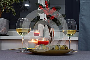 Evening dinner candles with a sushi and wine. Cozy home advent atmosphere