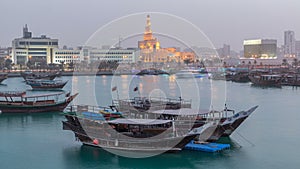 Evening at Doha Bay day to night timelapse with Traditional Wooden Dhow Fishing Boats.