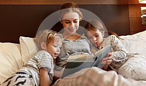 Evening family reading. mother reads children . book before going to bed
