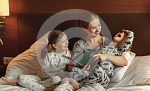 Evening family reading. mother reads children . book before going to bed