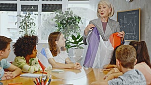 at evening geography lesson, elderly teacher tells attentive students about France