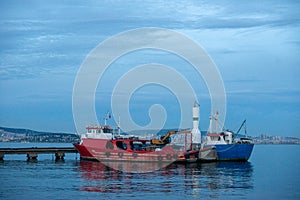 Evening at the Harbor: Red Fishing Boat and Sailboats