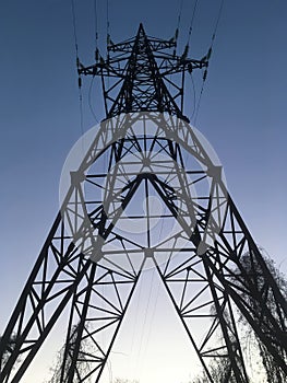 Evening high voltage power lines, electricity tower / pylon, diminishing perspective