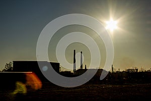 Evening landscape with factory pipes