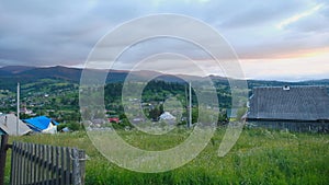 Evening landscape in the mountains. Alpine village view from the mountain. Summer mountain landscape in the Carpathians.