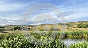 Evening landscape, with a pond, and extensive moorland near, Waterworks, Delph, UK