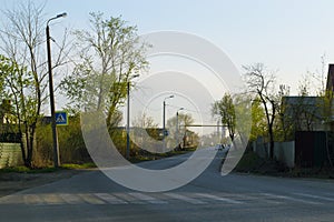 Evening landscape with a road on which cars are driving