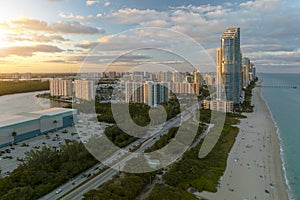 Evening landscape of sandy beachfront in Sunny Isles Beach city with luxurious highrise hotels and condo buildings on