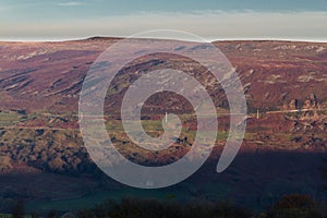 Evening light on hilltop with high road