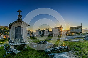 Evening light over granaries and stone storage sheds in the village of Lindoso in Portugal