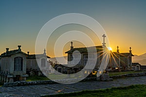 Evening light over granaries and stone storage sheds in the village of Lindoso in Portugal