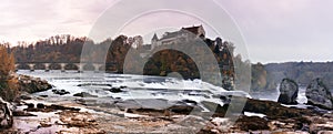 Evening light panorama landscape of the Rhine Falls and Laufen castle in Switzerland with very low water level in late autumn